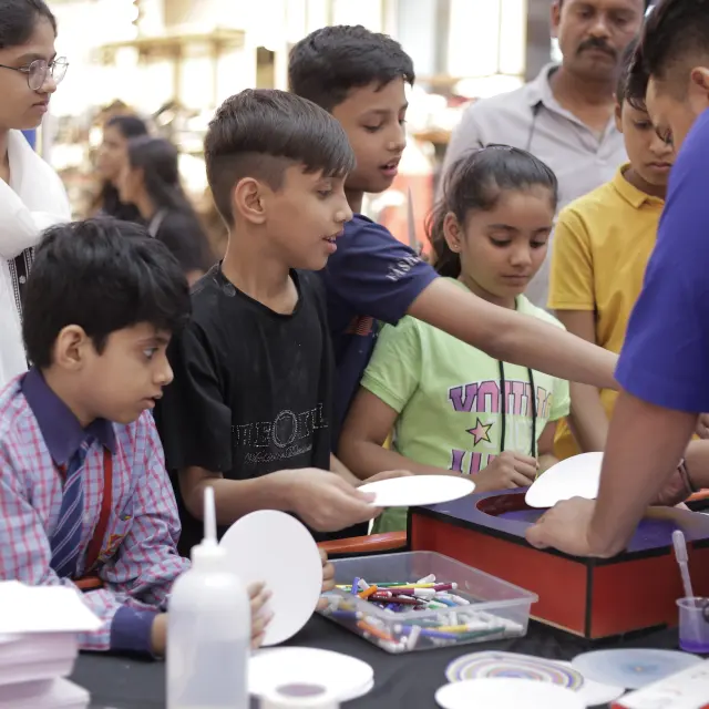 A child solving a physical science puzzle at a MakerMasti activity table