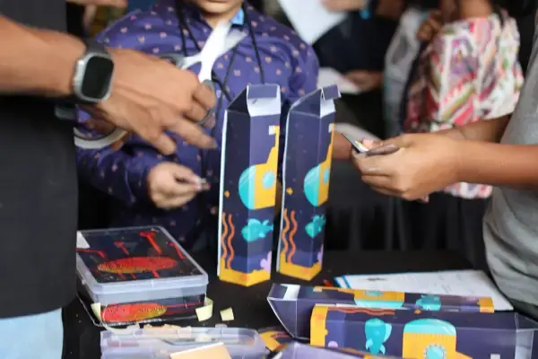 Children examining colourful spy dossiers and props at a Be a Detective birthday party